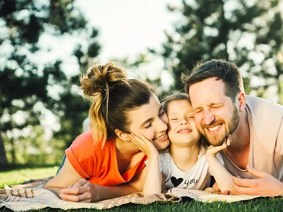 Family with bright smiles after cosmetic dentistry in Hondo, Texas